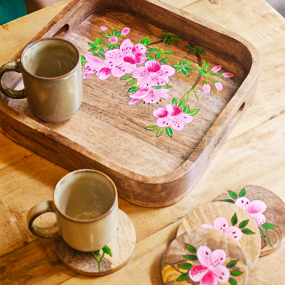 Detail shot of Yellow Marigold Handpainted Square Tray – Pink Azalea being finished by craftsmen, highlighting hand-painted floral art and wood texture.