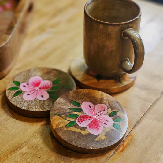 Close-up of Yellow Marigold hand-painted pink azalea artwork on mango wood coasters – premium serveware and gift-ready decor.
