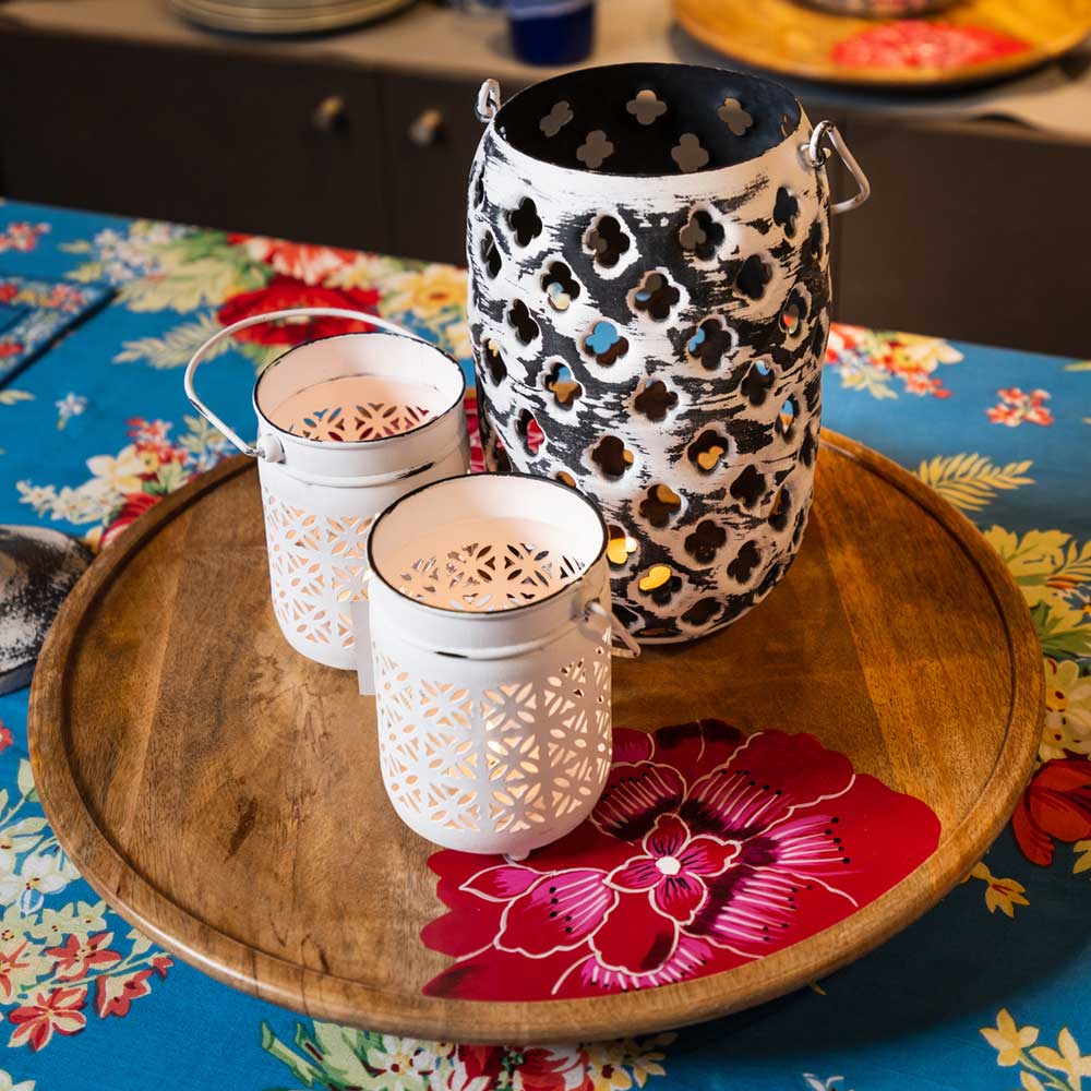 Yellow Marigold distressed metal hanging lantern hanging on a wooden porch / balcony light stand — cosy ambient lighting décor for home interiors