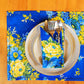 Yellow Marigold Avonlea Blue napkins (set of 6) placed beside crockery on a wooden dining table — elegant table setting