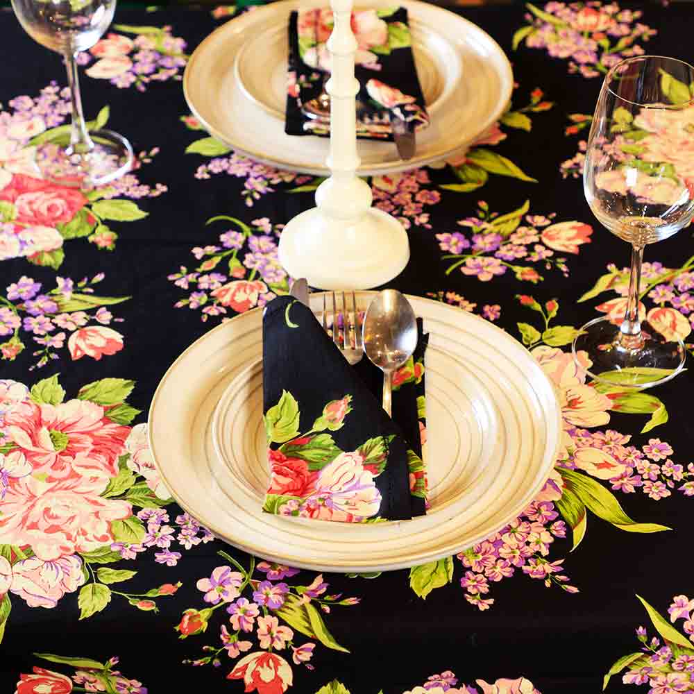 Yellow Marigold Blanche Black Floral Napkins (set of 6) placed beside crockery on a wood dining table — sophisticated table setting