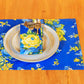 Yellow Marigold Avonlea Blue placemat — close-up view showing handcrafted fabric texture and floral pattern