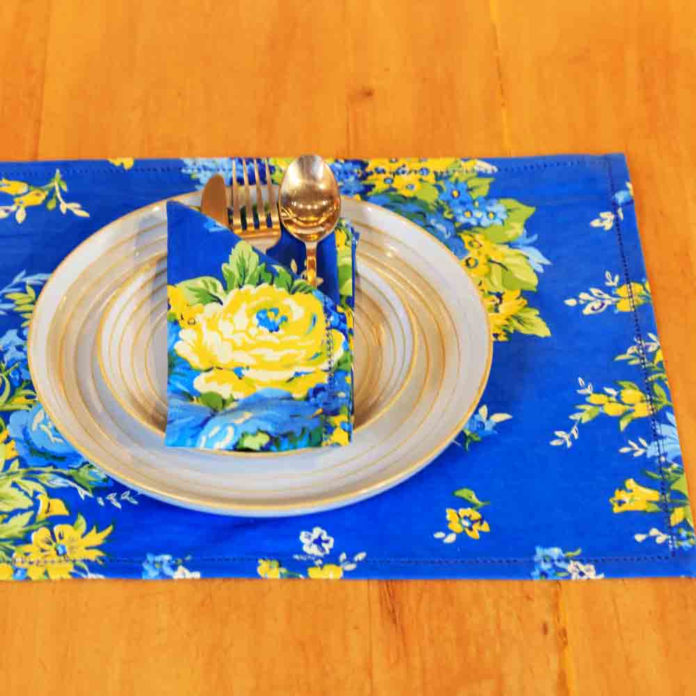 Yellow Marigold Avonlea Blue placemat — close-up view showing handcrafted fabric texture and floral pattern