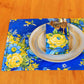 Yellow Marigold Avonlea Blue Placemats set of 6 — blue floral-print placemats arranged neatly