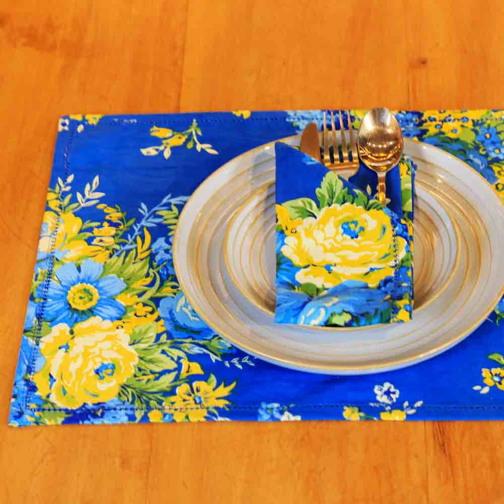 Yellow Marigold Avonlea Blue Placemats set of 6 — blue floral-print placemats arranged neatly