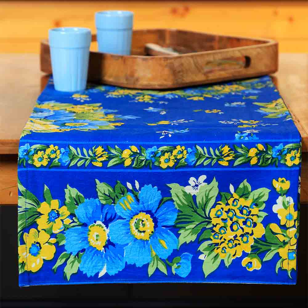 Yellow Marigold Avonlea Blue Floral table runner — blue floral-print table runner laid flat on dining table
