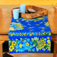Yellow Marigold Avonlea Blue Floral table runner on a wood dining table with crockery and décor — elegant home dining setup