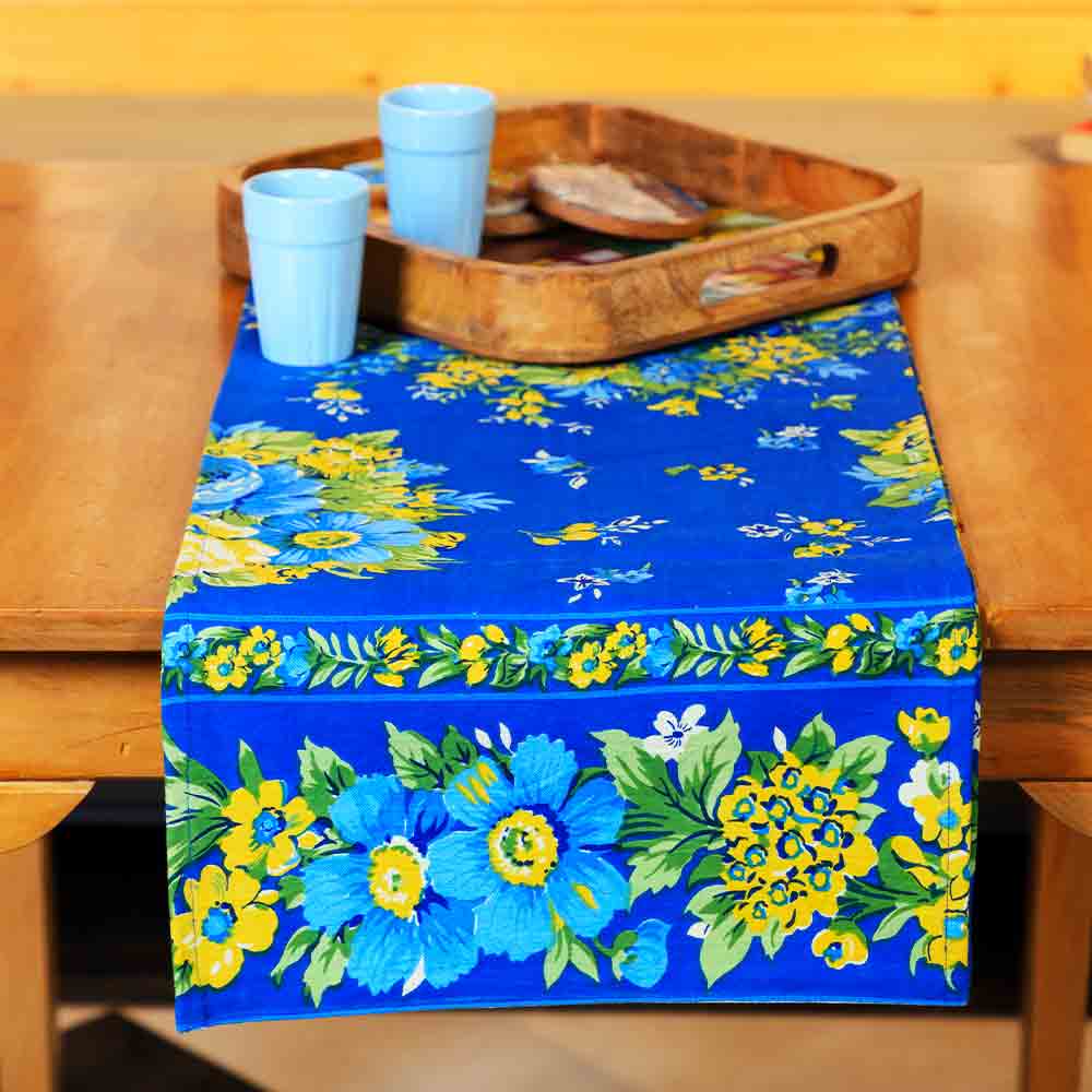 Yellow Marigold Avonlea Blue Floral table runner on a wood dining table with crockery and décor — elegant home dining setup
