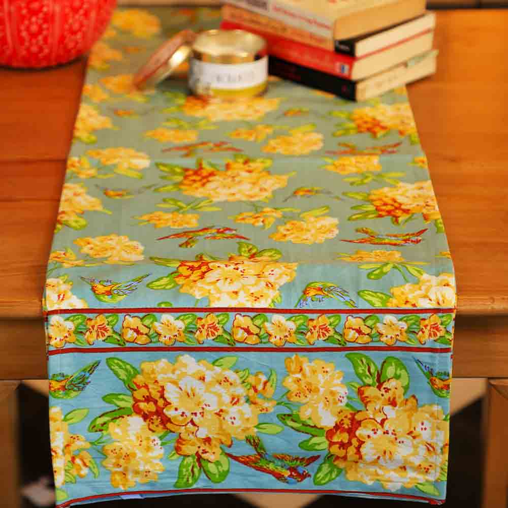 Yellow Marigold Valley of Flowers Mist table runner on a wood dining table with crockery and décor — elegant home dining ambience