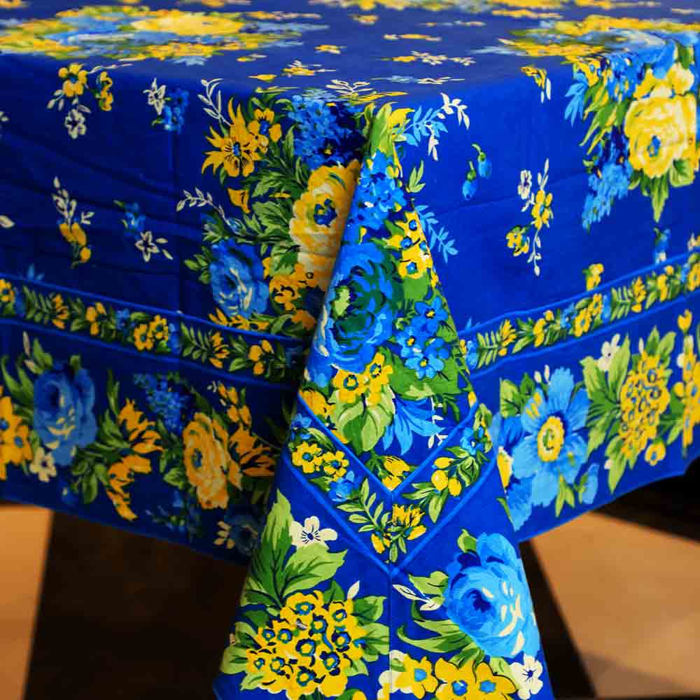 Yellow Marigold Avonlea Blue table cover — blue floral-print table cover spread flat on dining table