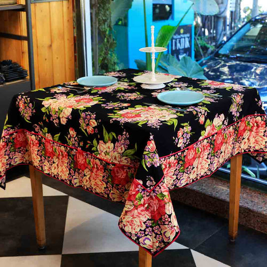Yellow Marigold Blanche Black Floral tablecloth — black floral-print tablecloth spread flat on a dining table